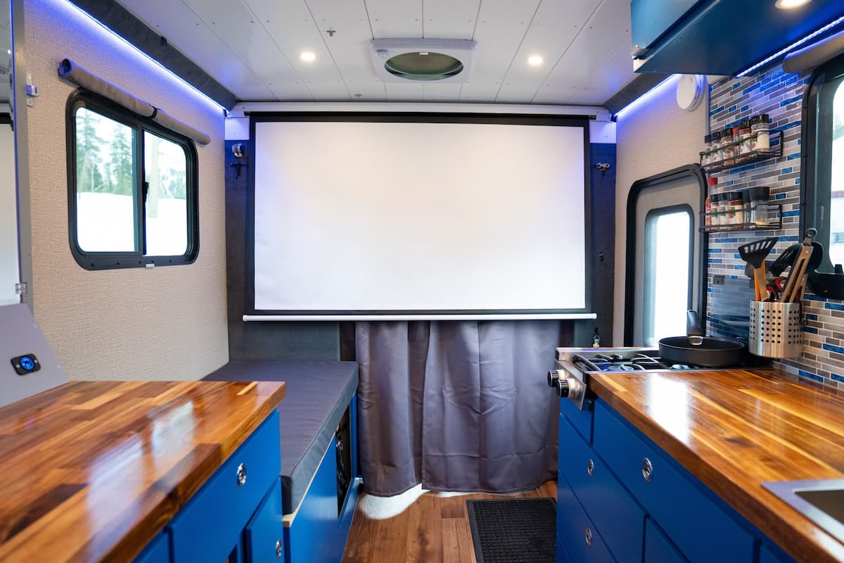 Custom ski van build in progress — projector screen and cabinetry